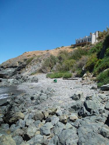 a pile of rocks on the side of a hill at Beach Villa Pantheon in Pomos