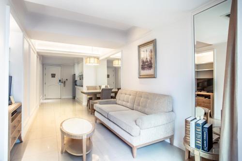 a living room with a couch and a table at Hope Land Hotel Sukhumvit 24 in Bangkok