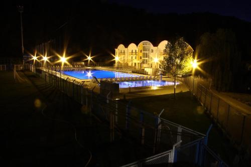 a large swimming pool at night with lights at Oras Zlatna in Zlatna