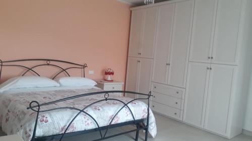 a bedroom with a bed and a white cabinet at Nel cuore di Coppito in Coppito