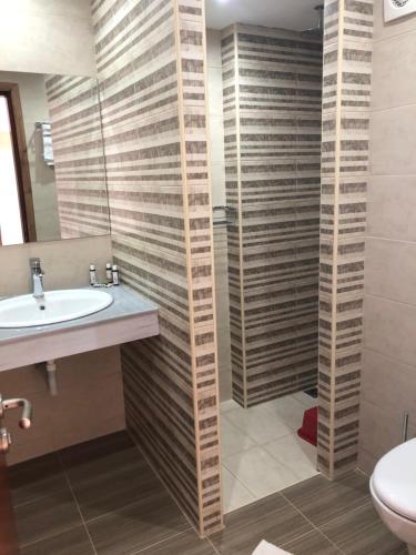 a bathroom with a sink and a toilet and a mirror at Anthoulis Studios in Kefalos