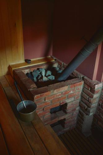 a brick oven with a bucket and a pipe at Beibuki in Naujene