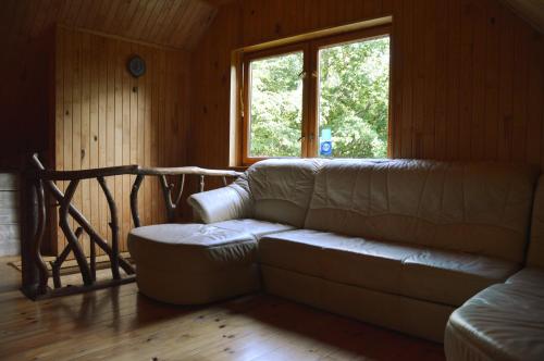 a living room with a couch and a window at Beibuki in Naujene