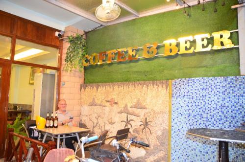 a man sitting at a table in a beer restaurant at Hoang Kim Hotel in Vientiane