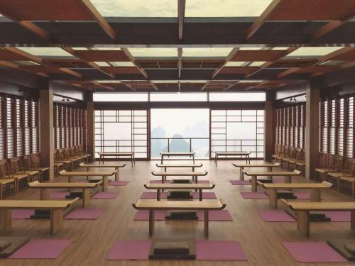 a large room with rows of tables and windows at Misty Wonderland ,Yangshuo Xingping in Yangshuo