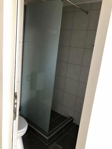 a shower stall in a bathroom with a toilet at Apartments Lukrecia in Neum