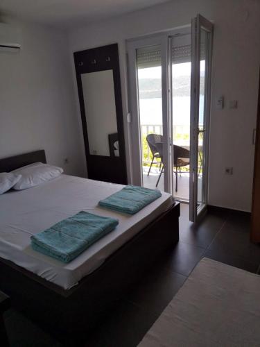 a bedroom with a bed with two towels on it at Apartments Lukrecia in Neum