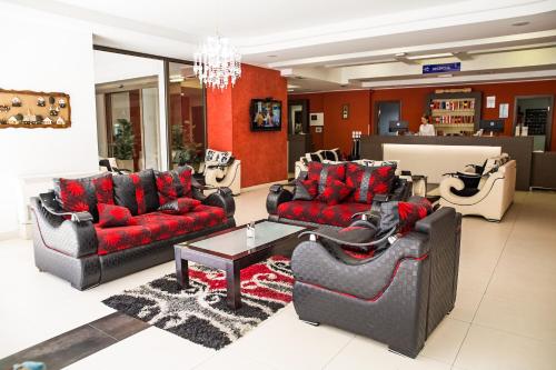 a living room with two couches and a table at Hotel Putnik in Novi Sad