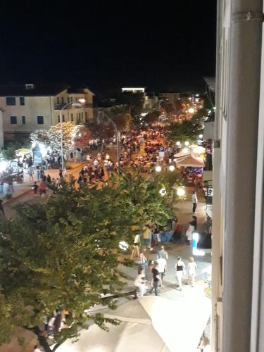 a crowd of people walking down a street at night at B&B Centrale in Tortolì