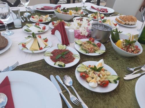 a long table with plates of food on it at Club Turtas Beach - All Inclusive in Konaklı