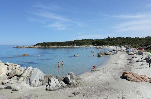 a group of people in the water on a beach at B&B Centrale in Tortolì