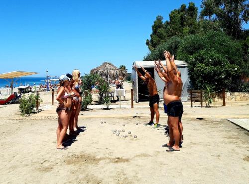 a group of people standing on a beach at Club Turtas Beach - All Inclusive in Konaklı
