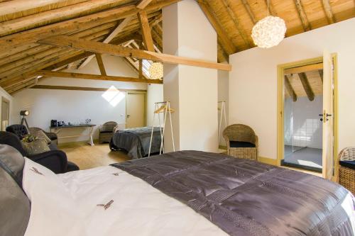 a bedroom with a bed and a living room at Gasterij Leyduin in Vogelenzang