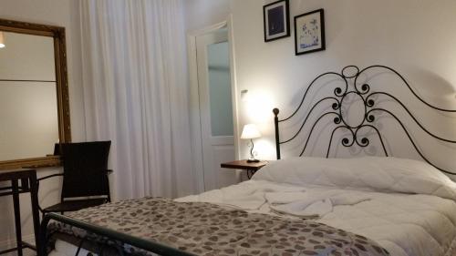 a bedroom with a bed and a desk and a mirror at Nossa Casa na Aldeia in Viseu