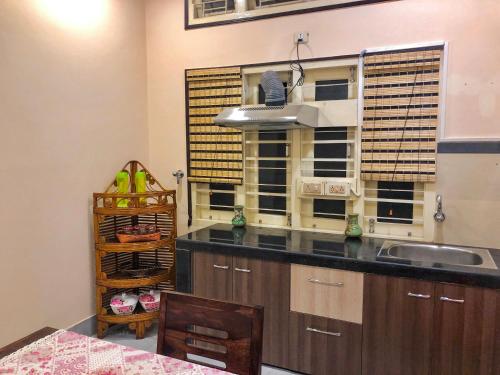 a kitchen with a sink and a counter top at Bougainvillea in Guwahati
