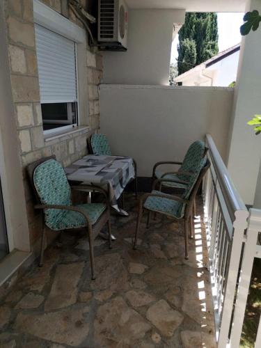 a patio with a table and chairs on a balcony at Apartments Lukrecia in Neum