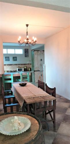 a dining room with a wooden table and chairs at Appartement Blue Coast in Mahébourg