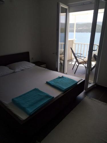 a bedroom with a bed with two towels on it at Apartments Lukrecia in Neum