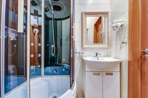a bathroom with a sink and a shower at Sunflower River Hotel Moscow in Moscow