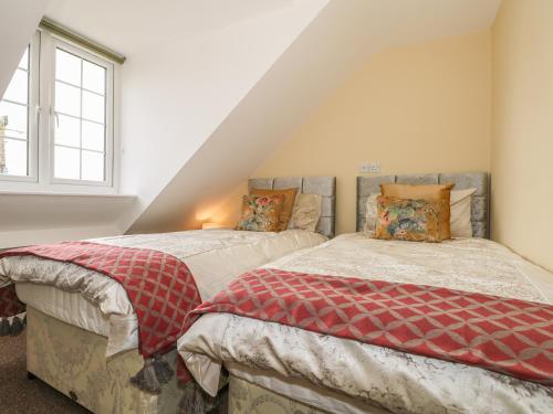 two beds in a room with a attic at Beau Annexe in Ringwood
