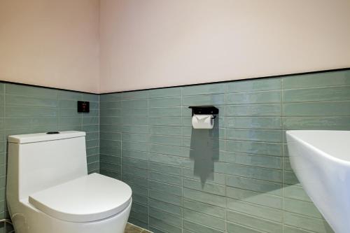 a bathroom with a white toilet and a sink at PACE HOTEL Suzhou Guanqian Branch in Suzhou