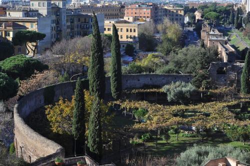 a view of a garden with trees and buildings at Domus Sessoriana in Rome