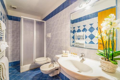 a blue and white bathroom with a sink and a toilet at Agriturismo Settepassi Tuscany in Ponte Buggianese