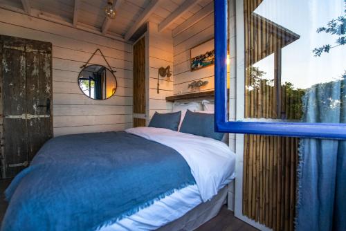 a bedroom with a bed in a room with a window at Les Maisons de pêcheur avec Jacuzzi in Sète