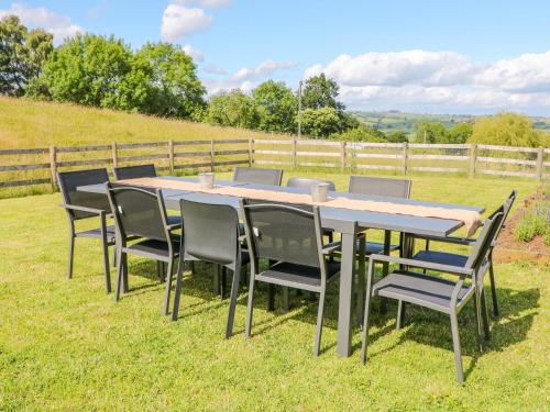 a table and chairs on the grass in a field at Highcroft in Belper