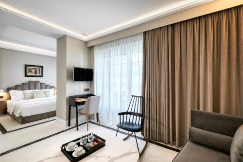a hotel room with a bed and a desk at Athenian Foss in Athens