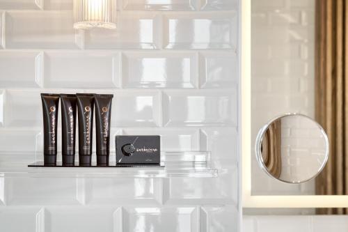 a shelf with books and a mirror in a bathroom at Athenian Foss in Athens