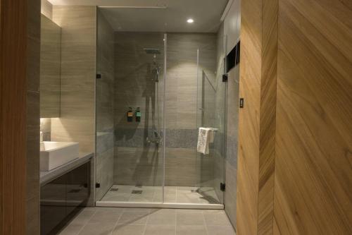 a shower with a glass door in a bathroom at K HOTEL in Taichung