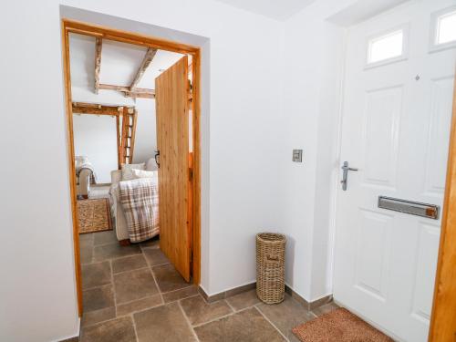 a hallway with a door leading to a bedroom at Duck Pond Cottage in Spalding