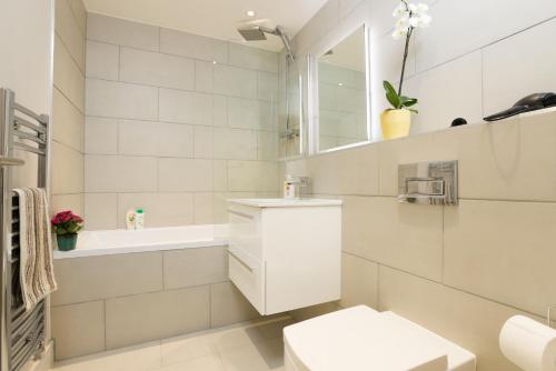 bagno bianco con lavandino e servizi igienici di 7-11 Kings Park a Bicester