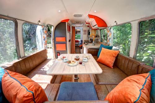 a dining room in an rv with a table and chairs at Glamping 1970 American Airstream motorhome in Ponsanooth