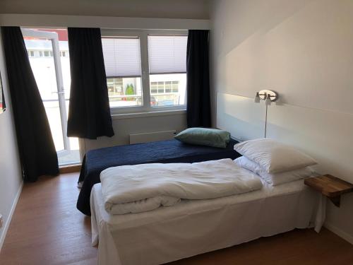Postel nebo postele na pokoji v ubytování Husnes Sentrum Hotell