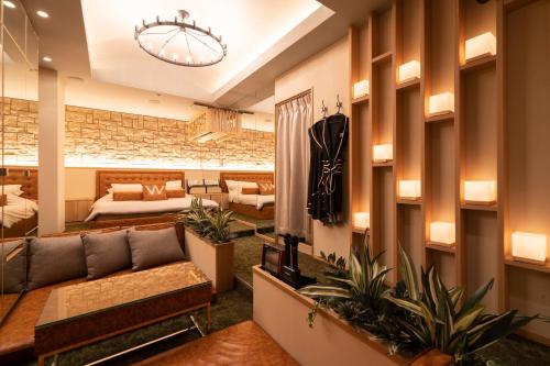 a living room with a couch and some plants at Design Hotel W Zip Club in Nagoya
