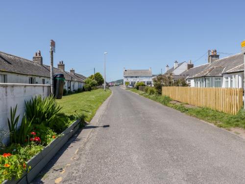 an empty street in a village with houses at Mardan in Dumfries