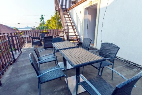 a table and chairs sitting on a balcony at Balaton Vendégház Fonyód in Fonyód