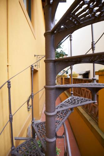 a metal spiral staircase next to a building at Green Nest Apartments in Florence