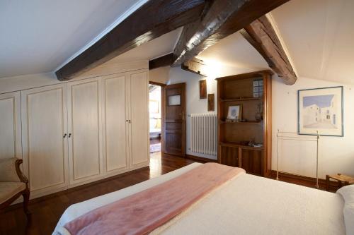 a bedroom with a white bed and wooden ceilings at Green Nest Apartments in Florence
