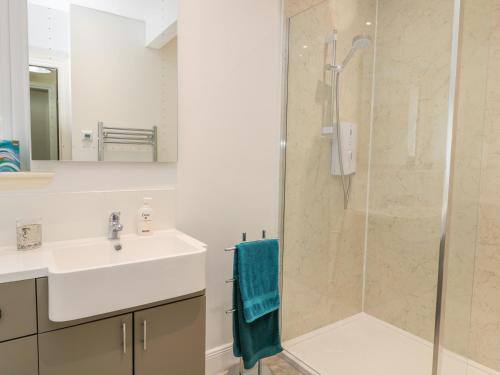 a bathroom with a sink and a shower at Falla Farmhouse in Jedburgh