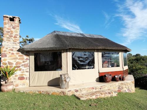 a gazebo with a thatched roof and some plants at Natures Gem of Mosselbay in Mossel Bay
