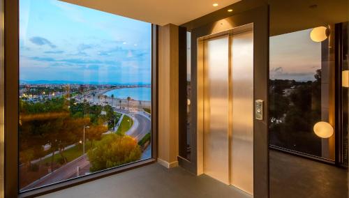 a room with a large window with a view at Golden Costa Salou - Adults Only 4* Sup in Salou