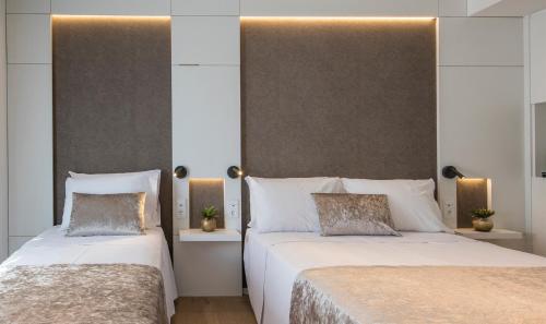 two beds sitting next to each other in a bedroom at Golden Costa Salou - Adults Only 4* Sup in Salou