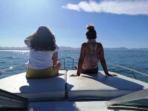 two women sitting on a boat in the water at Natures Gem of Mosselbay in Mossel Bay