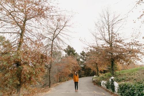 a woman walking down a path in a park at Zevenwacht Country Inn in Kuilsrivier