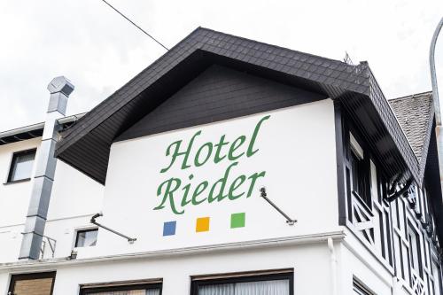 a building with a hotel relief sign on it at Hotel Rieder in Wiesemscheid