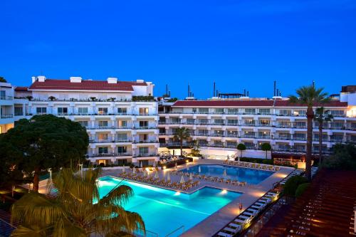 a hotel with a large swimming pool at night at Aqualuz Lagos by The Editory in Lagos