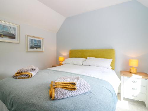 a bedroom with two beds and two lamps at 2 Tougal in Mallaig